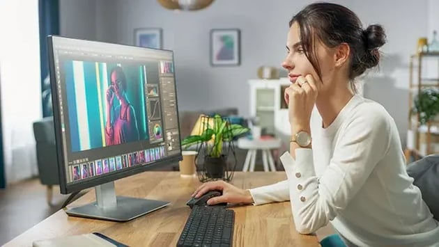 615c97779f42535e80add02c_Woman using Adobe Suite together with Cortex DAM_650