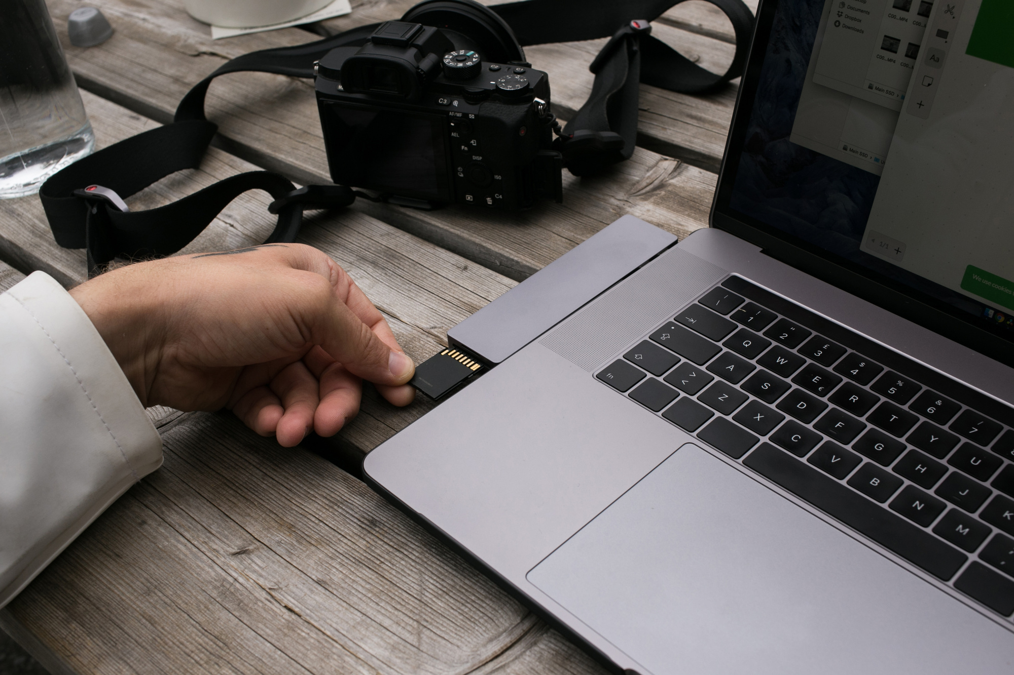 Creative professional connecting a memory card to a laptop