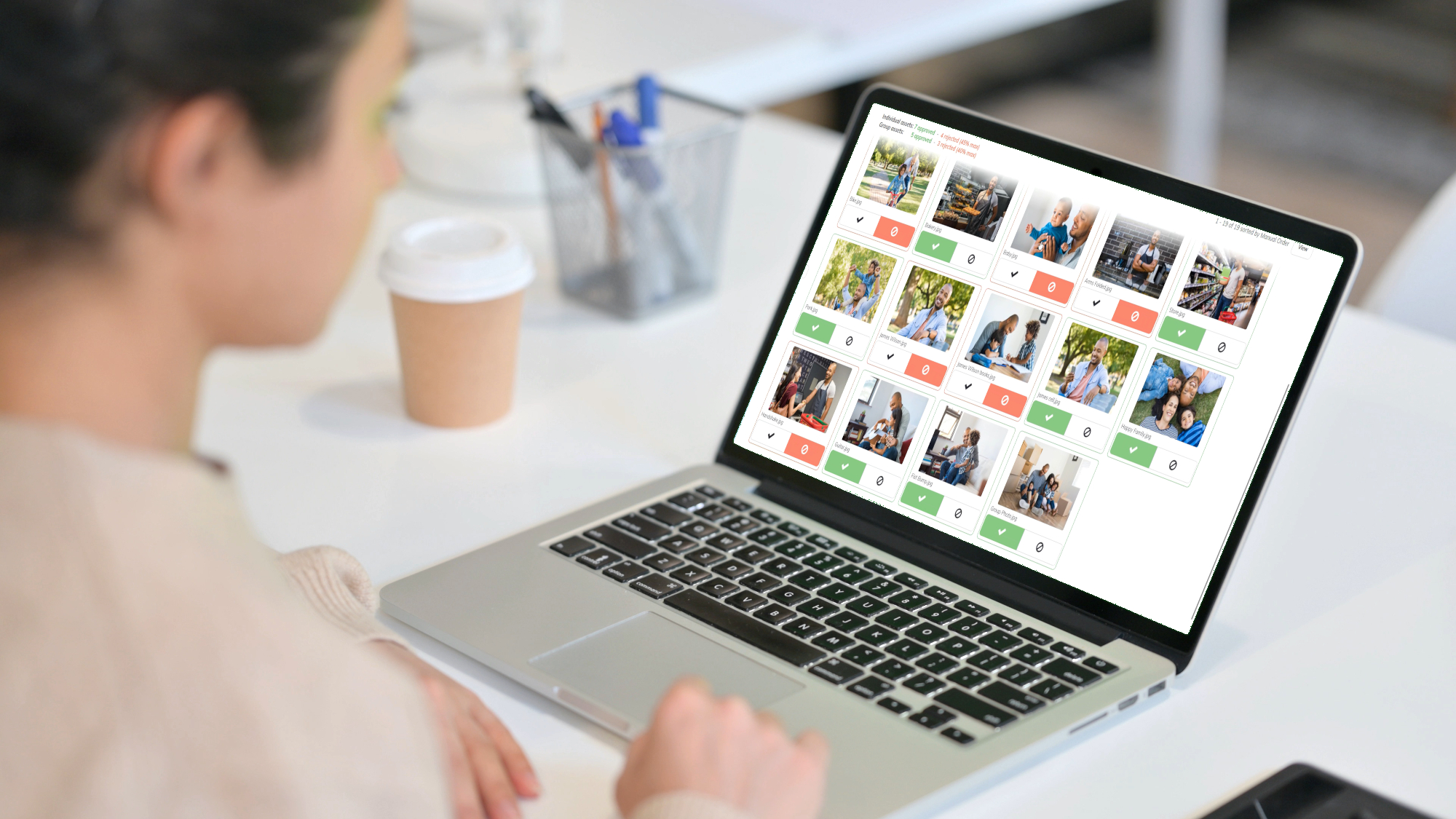 Woman uses talent approval software to review images