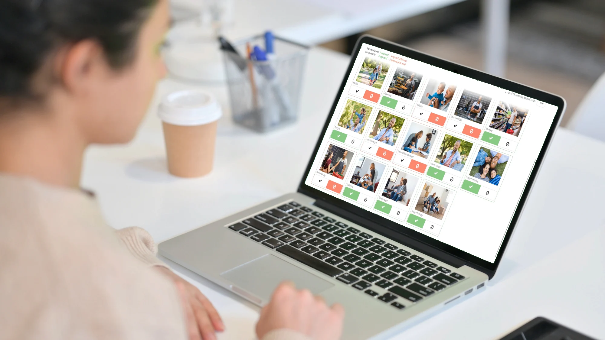 Woman uses talent approval software to review images